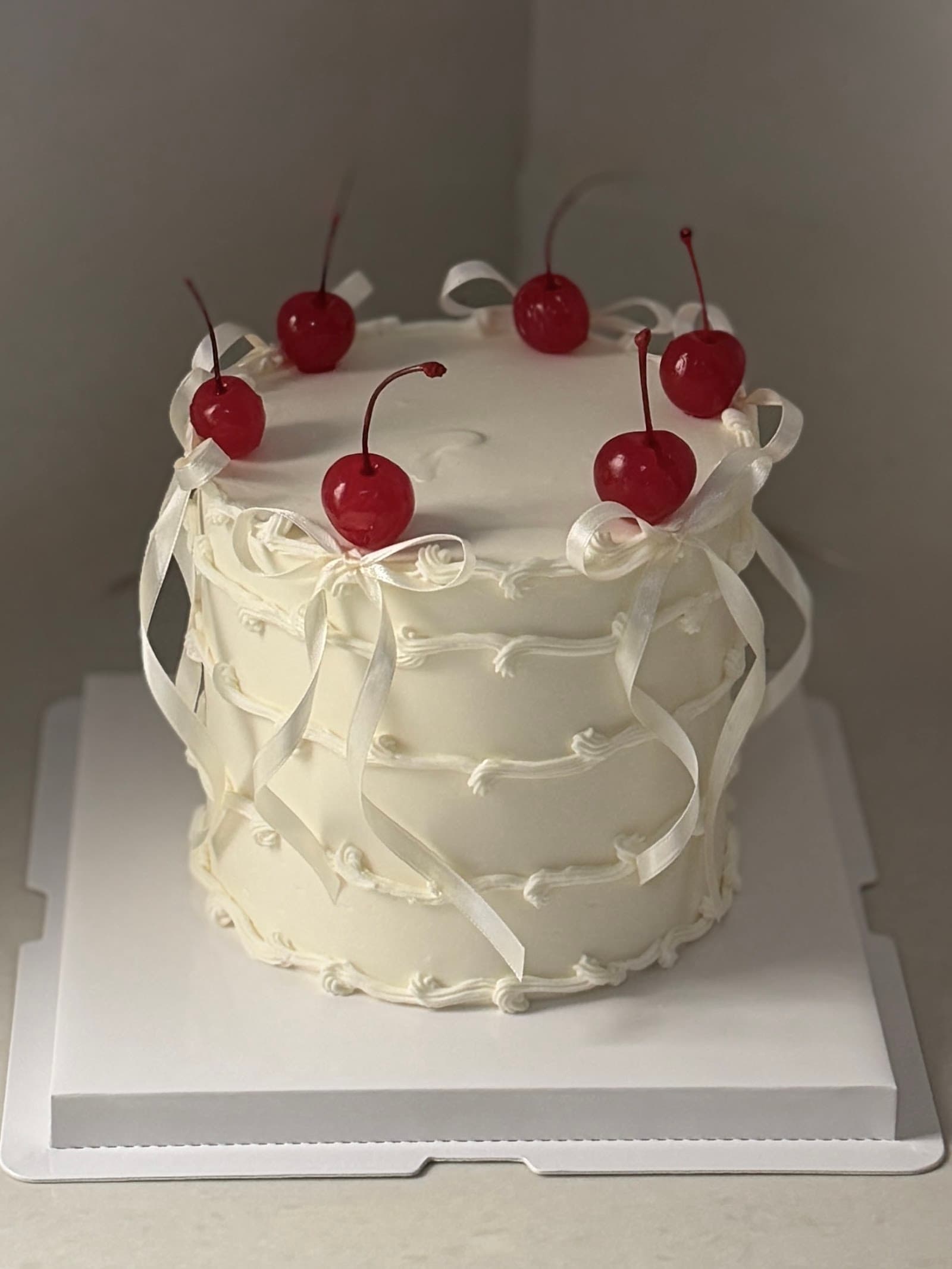 Cocktail cherries n bows buttercream cake